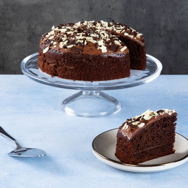 Chocolate cake with chocolate icing and white chocolate shavings.