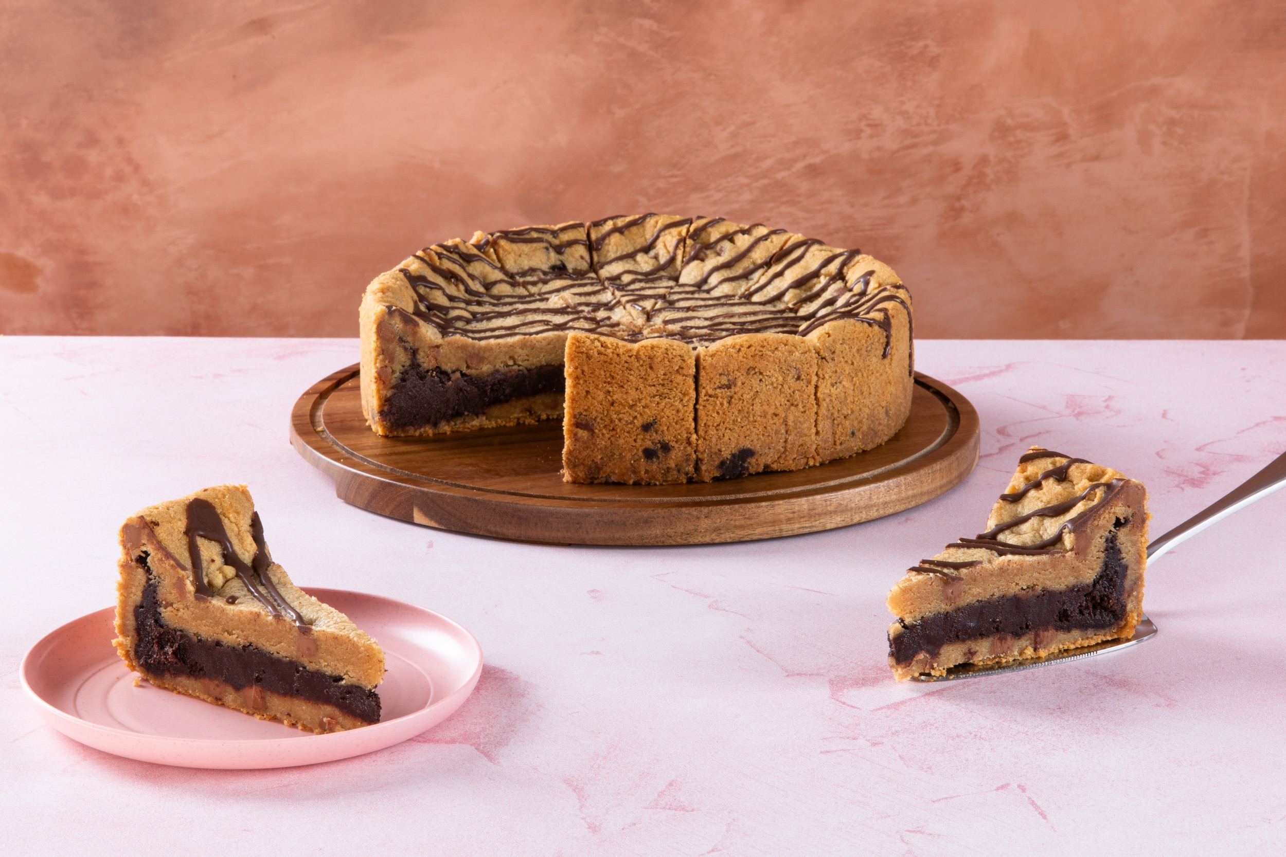 Sliced chocolate brownie cookie pie with drizzle topping