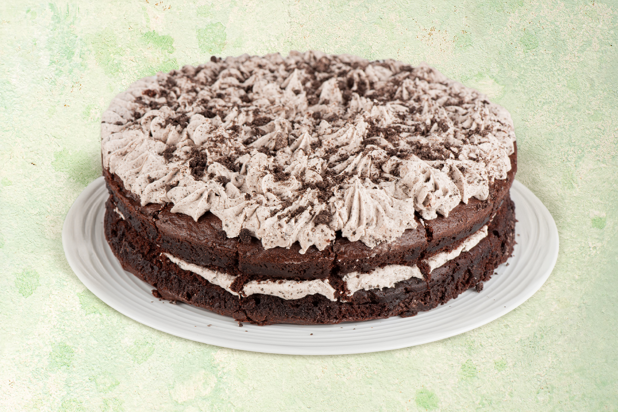 Vegan cookies and cream cake with chocolate cookie topping.